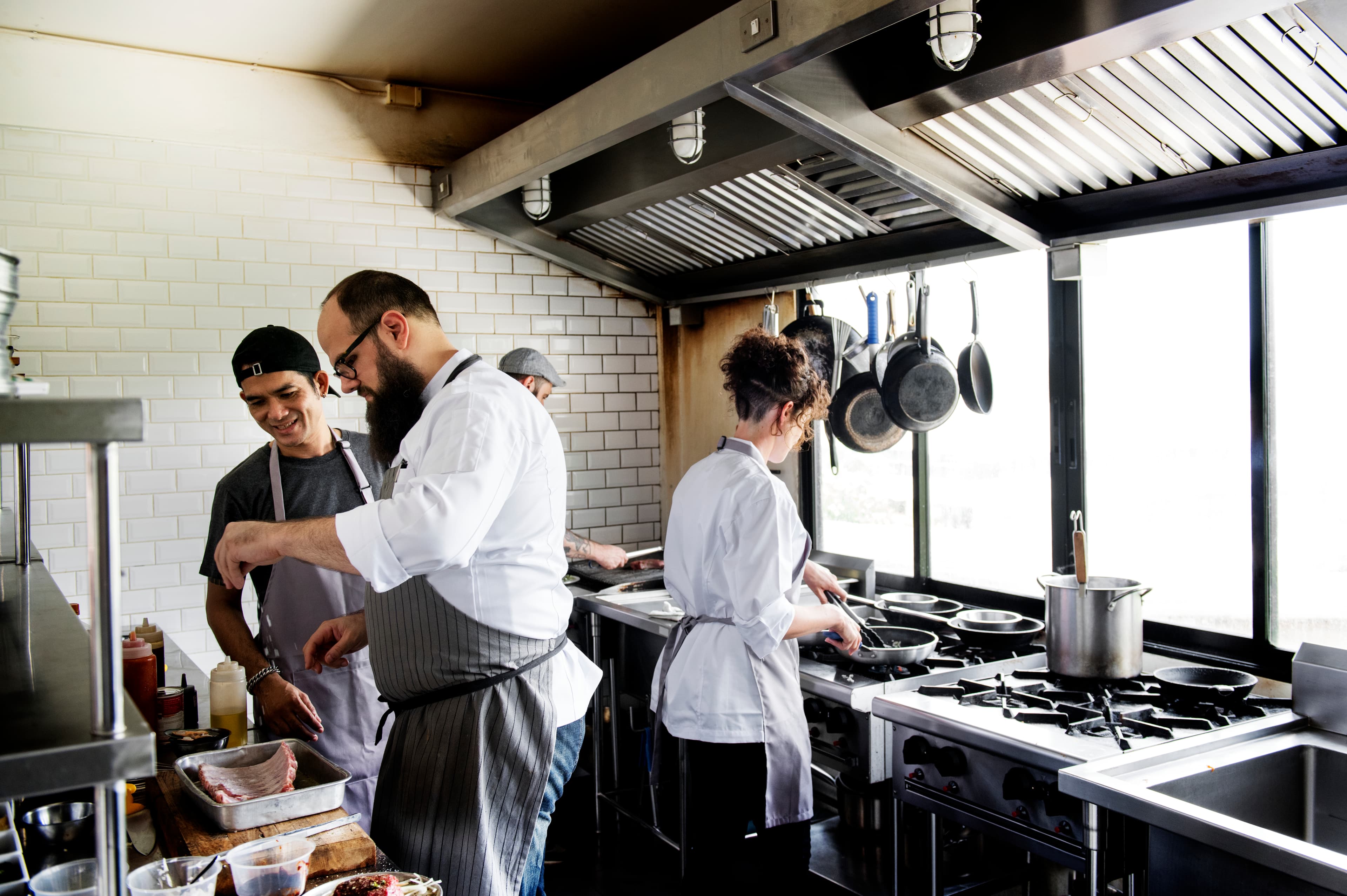 Group of chefs working in busy restaurant kitchen